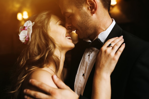 Free photo newlyweds looking at each other's face and smiling