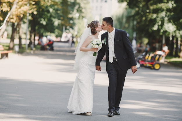 Newlyweds walking and kissing