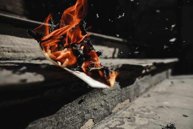 Newspaper is burning outdoors on the stairs