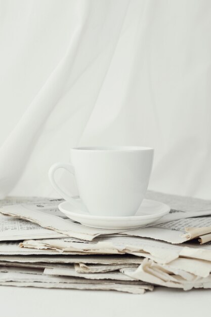 Newspapers and coffee cup