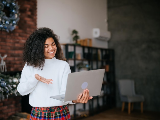 Nice attractive lovely overjoyed crazy cheerful cheery wavyhaired girl holding in hands laptop goal achievement