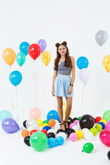 Nice woman in cool summer outfut posing with balloons