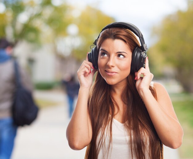 Nice woman listening music in headphones