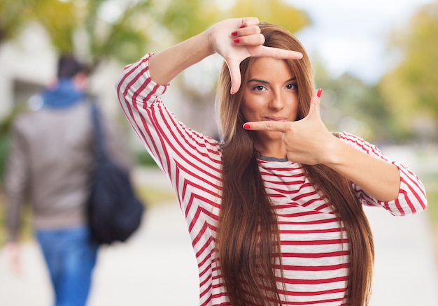 Nice woman making hand photo gesture