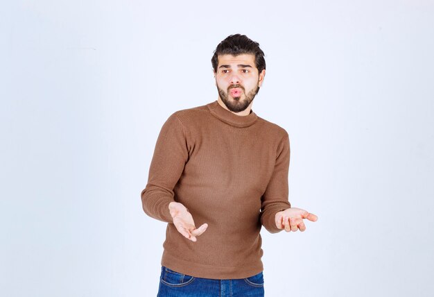 nice young man model standing and posing with raising hands.