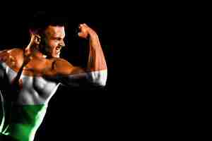 Free photo niger flag on handsome young muscular man black background