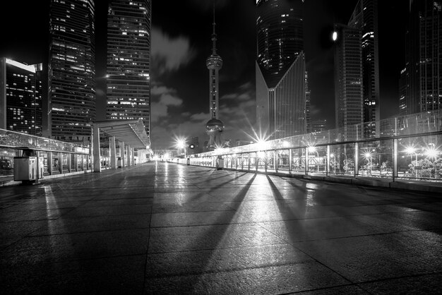 night view of empty brick floor front of modern building