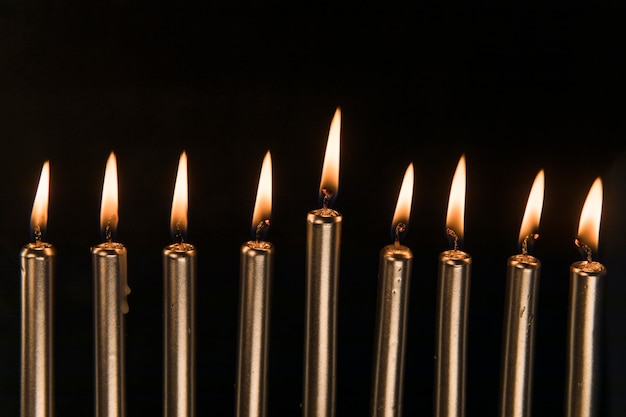 Nine golden candles with small flame