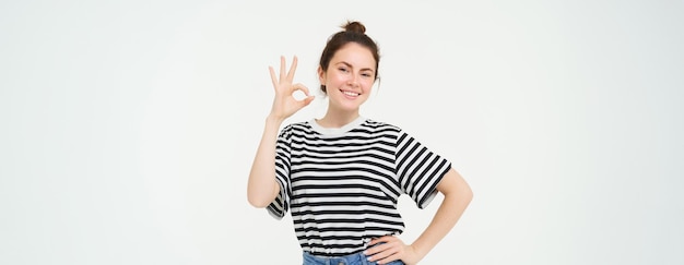 Free photo no problem excellent choice smiling confident young woman showing okay ok sign zero gesture