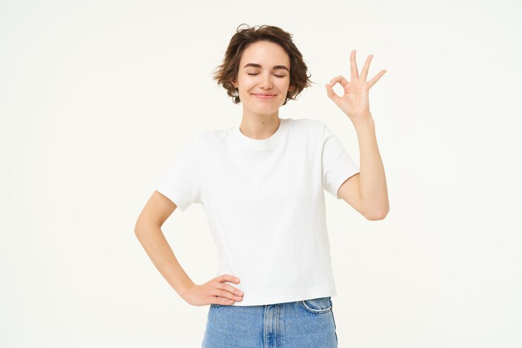 Free Photo no problem portrait of young woman standing in confident pose shows okay ok zero gesture stands over