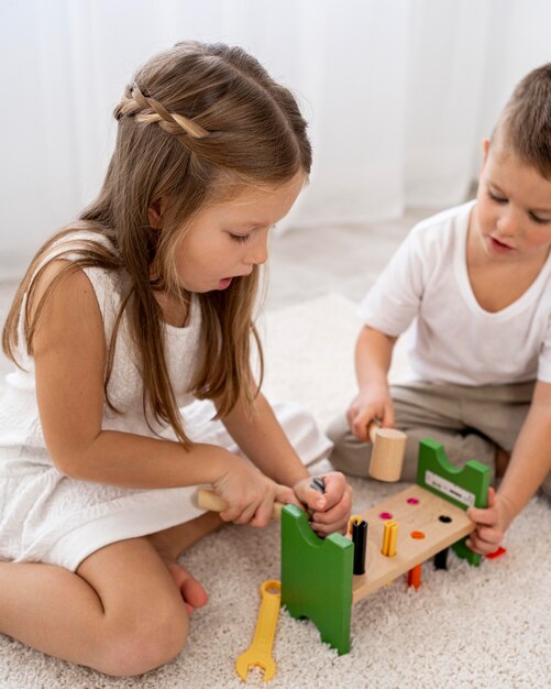 Non-binary kids playing with colorful game