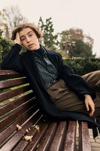 Non binary person sitting on the bench