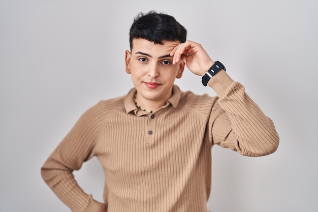 Free photo non binary person standing over isolated background worried and stressed about a problem with hand on forehead nervous and anxious for crisis