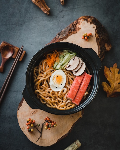 Free photo noodle pasta with vegetables and egg on bowl, top view