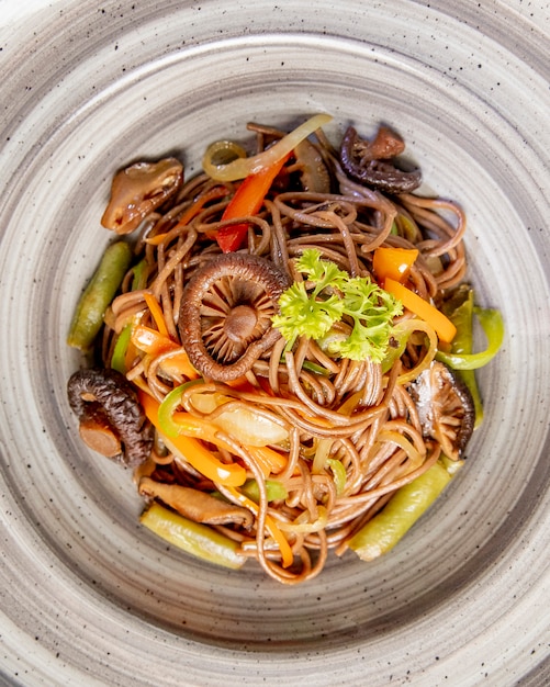 Noodles prepared with mushrooms bell peppers and sauce