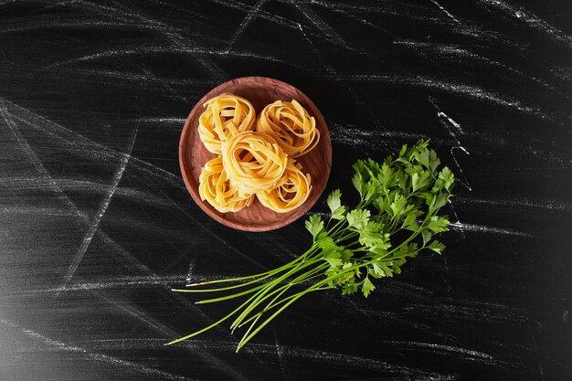 Noodles served with fresh parsley bunch. 