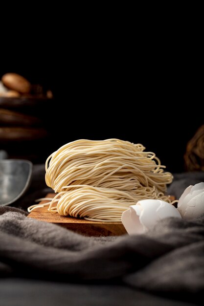 Noodles on a wooden support on a black background