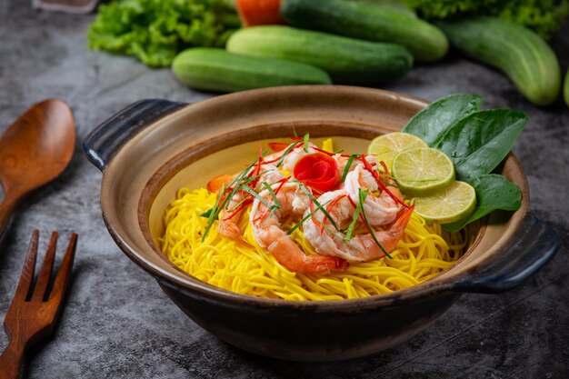 Northern Thai food (Khao Soi shrimp), spicy noodles decorated with ingredients.