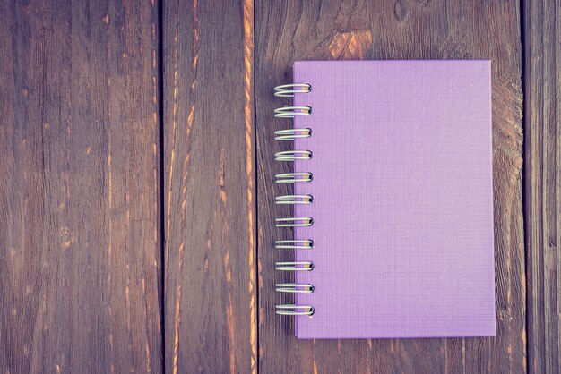 Note book on wooden background