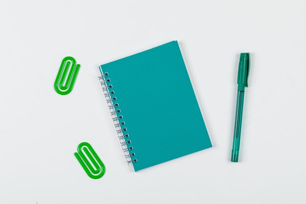 Note taking concept with notebook, pen, paper clips on white background top view. horizontal image