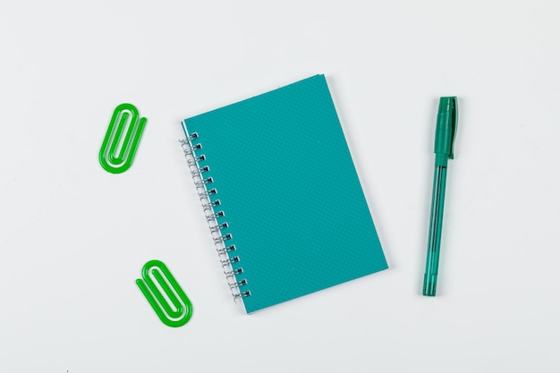 Note taking concept with notebook, pen, paper clips on white background top view. horizontal image