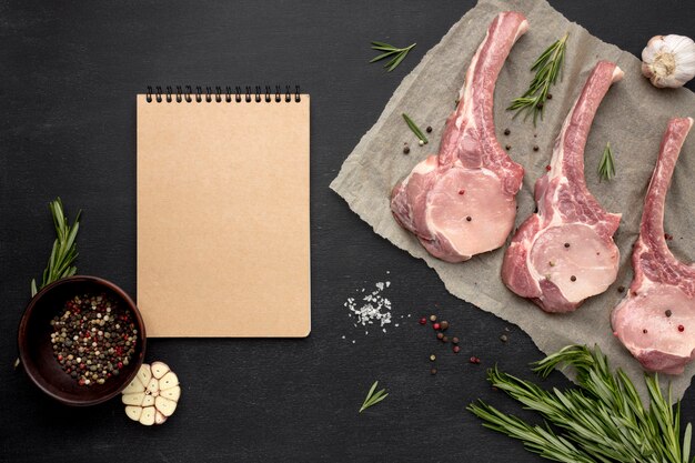 Notebook beside raw meat on baking paper