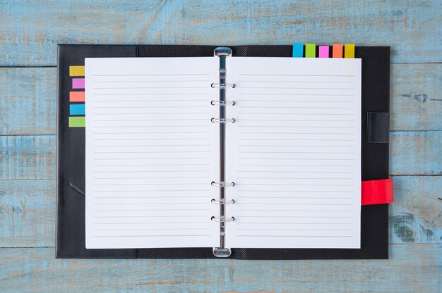 Notebook on blue wood table 