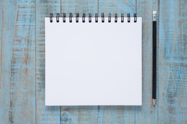 Notebook on blue wood table 