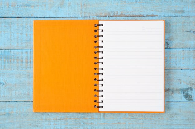 Notebook on blue wood table 