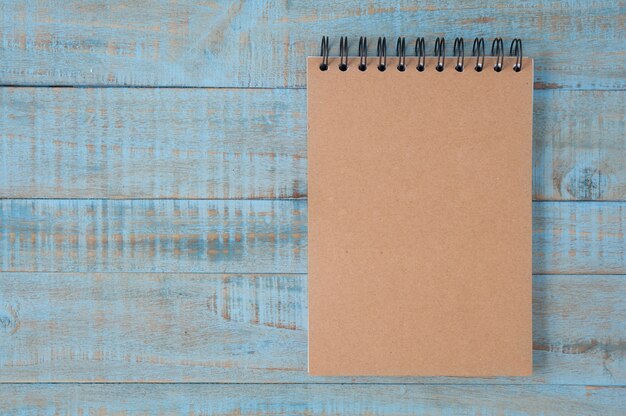 Notebook on blue wood table 