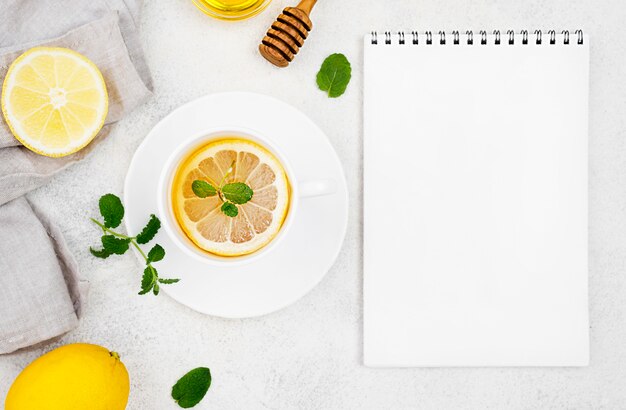 Notebook cup with lemon tea