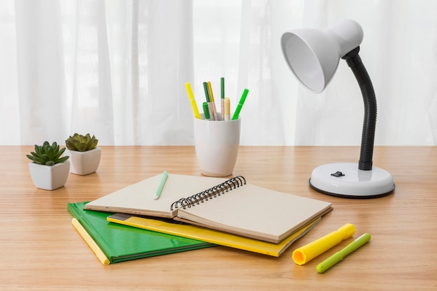 study table elevation Free photo notebook and lamp on desk high angle