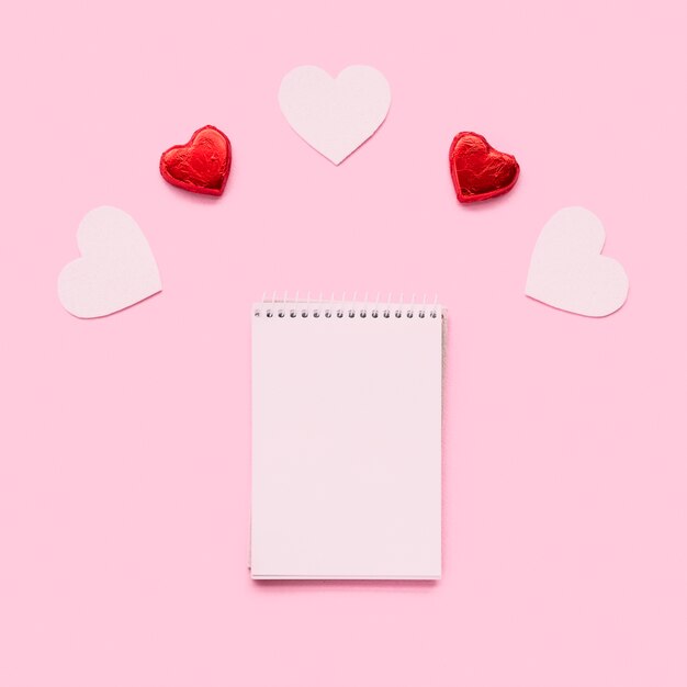 Notebook near ornament hearts 
