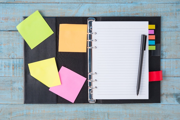 Free Photo notebook  and pen on blue wood table 