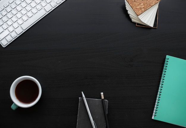 Notebook Pencils Coffee Cup Workspace on Black Table