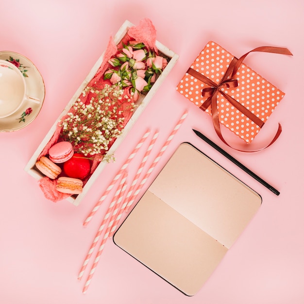 Free photo notebook and present near dessert and cup