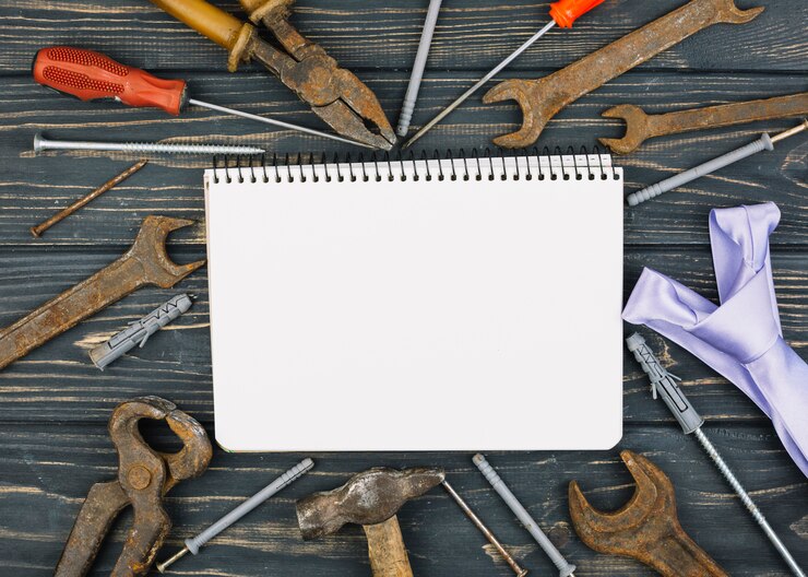 Free Photo notebook between set of repair equipments and tie