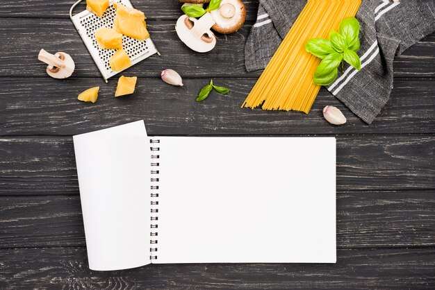 Notebook and spaghetti with mushrooms