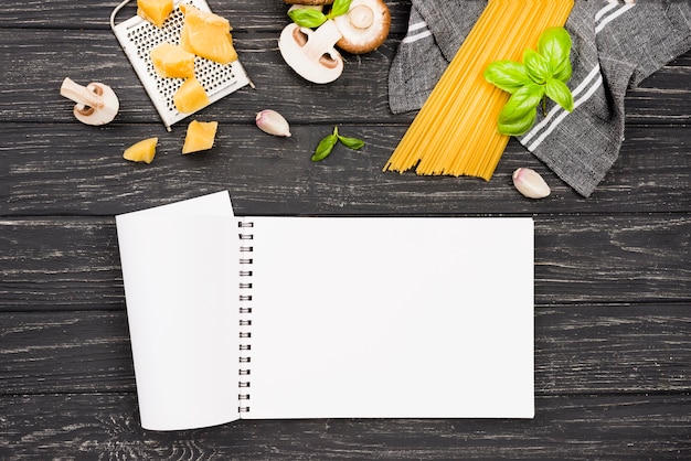 Notebook and spaghetti with mushrooms