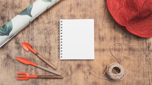 Notebook surrounded with gardening elements 