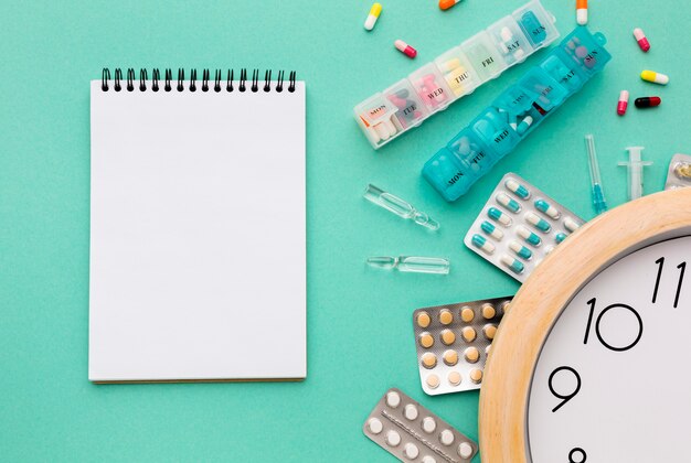 Notebook and tablets with pills on desk