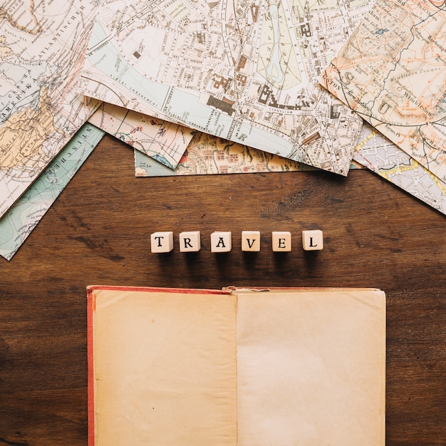 Notebook and travel writing near maps