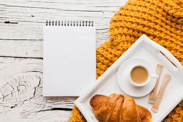 Notebook and tray with breakfast