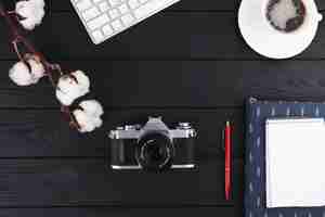 Free photo notebook with camera and coffee on table