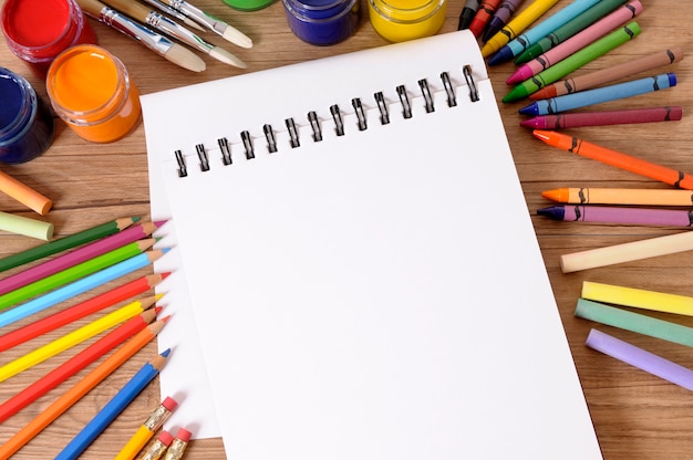 Free photo notebook with coloured pencils