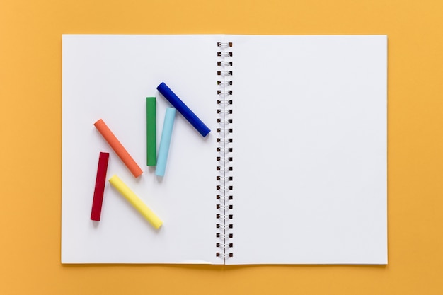 Free photo notebook with crayons