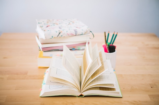 Notebook with flipping pages near stationery