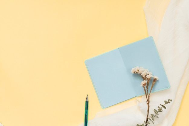 Notebook with flowers branch and pen