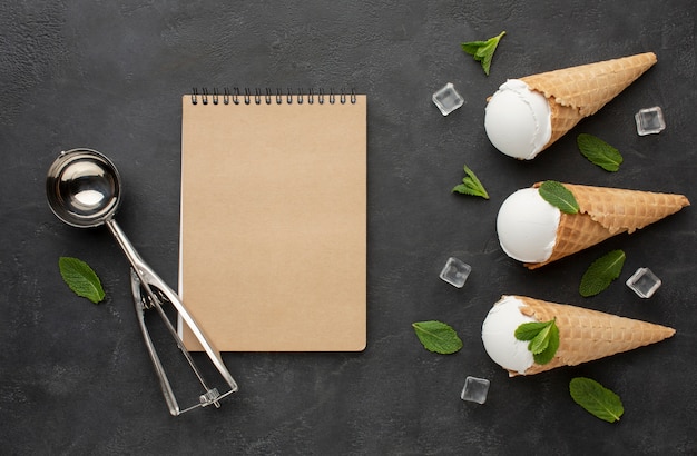 Free photo notebook with ice cream on cones with ice cubes