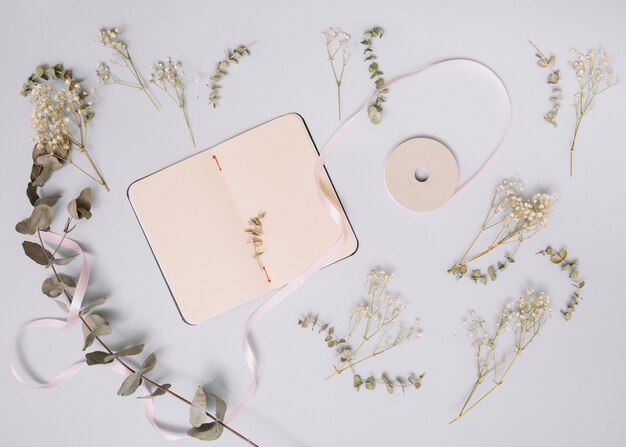 Notebook with small branches on table